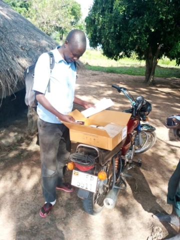 A volunteer using motorcycle to deliver TB drugs to TB clients attached to Orum HC IV for TB missed appointment and due for pick up